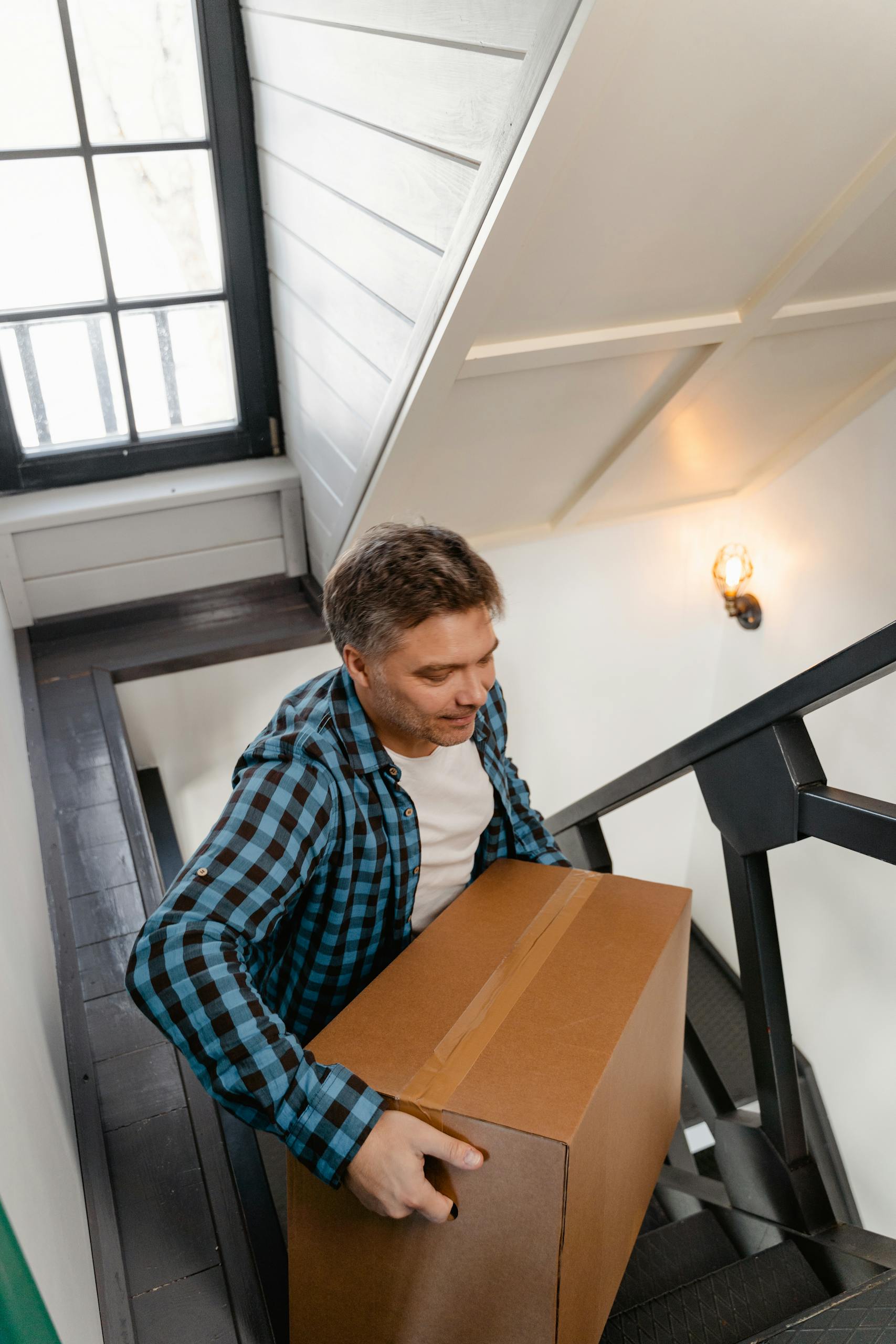 High Angle Shot of Man Carrying Box